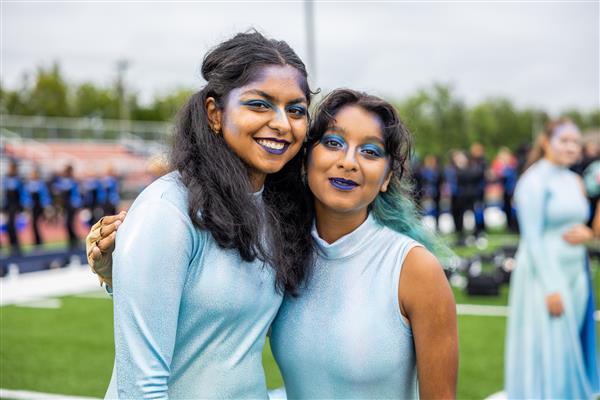 Two color guard members smile